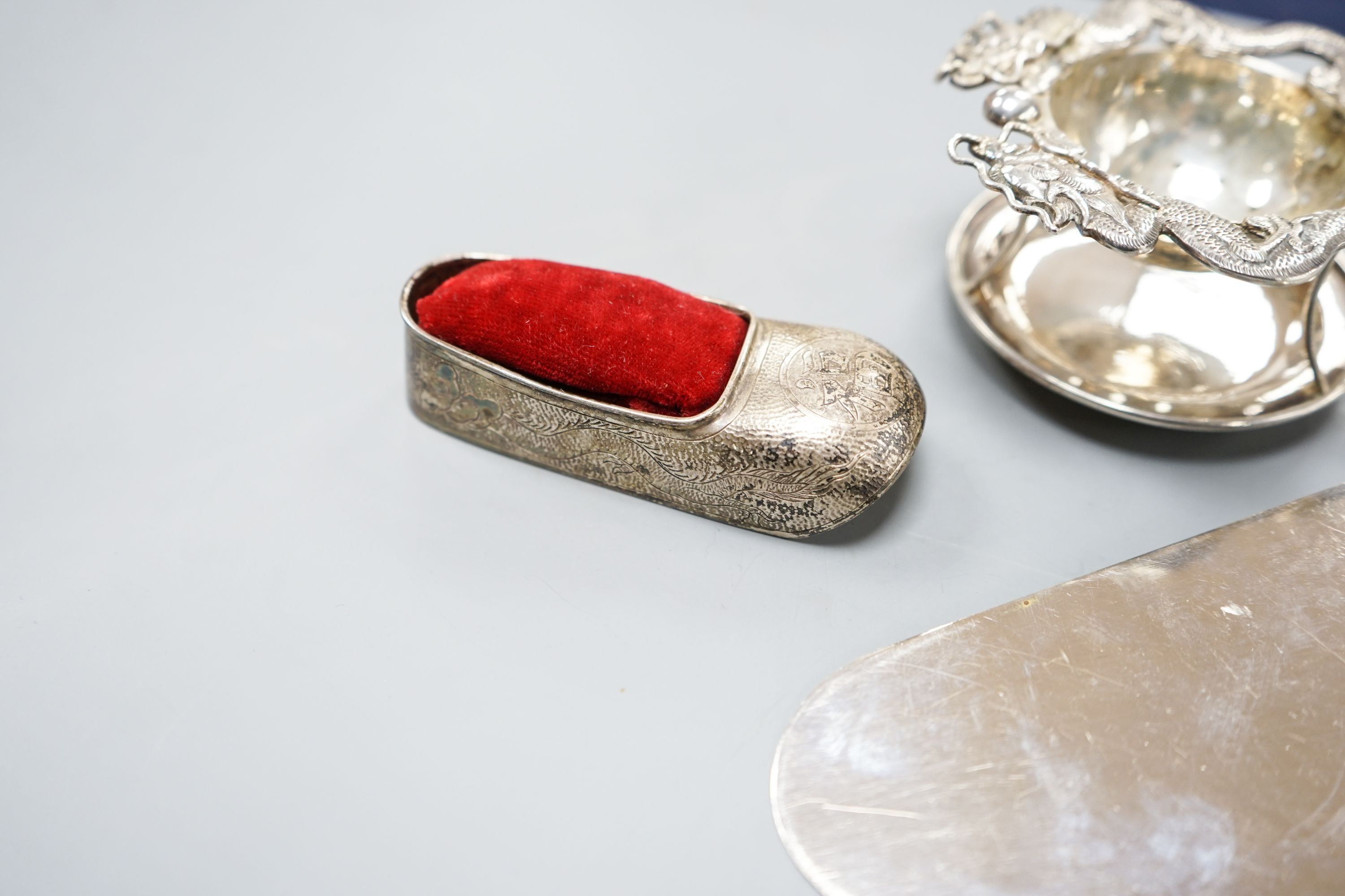 A Chinese white metal cake slice by Tack Hing, 24.4cm and a tea strainer on stand, pair of sugar tongs and pin cushion by Kingsburg, Hong Kong.